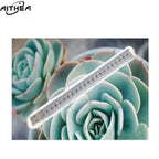 AITHEA portable USB LED grow light bar with a clear plastic casing, positioned over a green succulent plant.