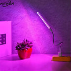 Portable AITHEA LED grow light bar with a flexible neck, emitting a vibrant purple spectrum over a small potted succulent.